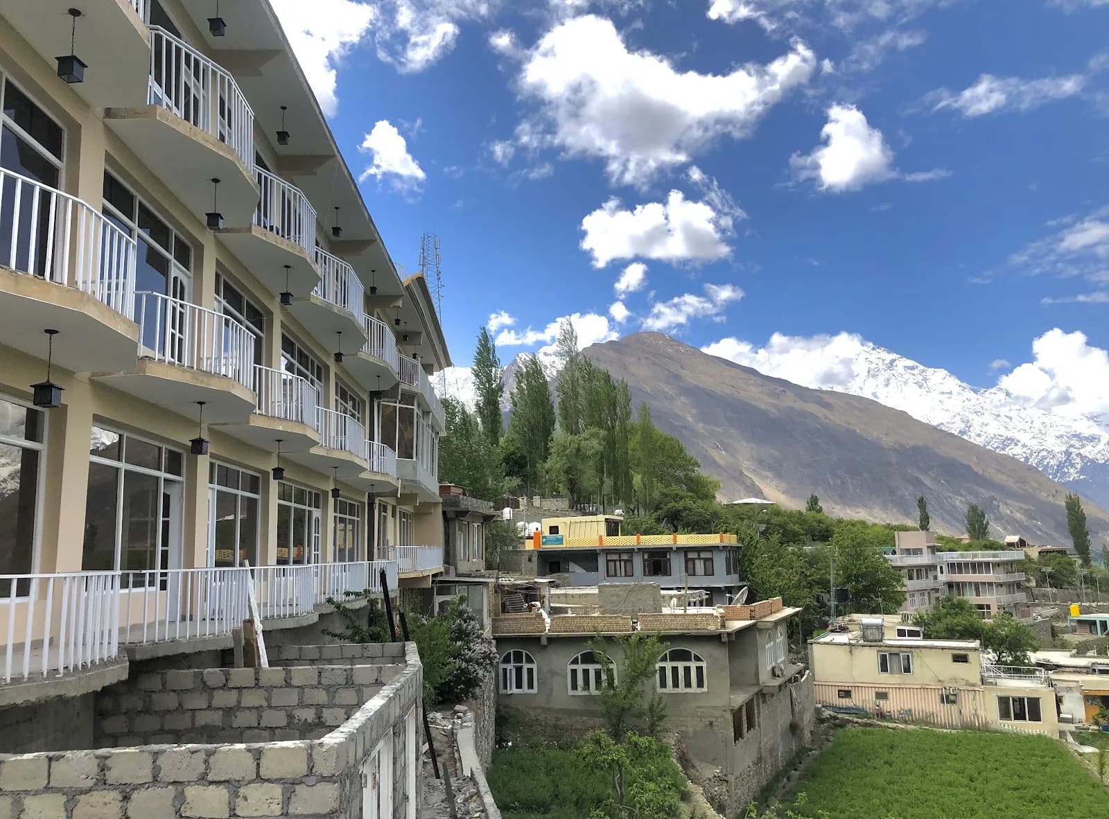 Hilltop Hotel Hunza's balconies with a snow-covered Karakoram peak beyond